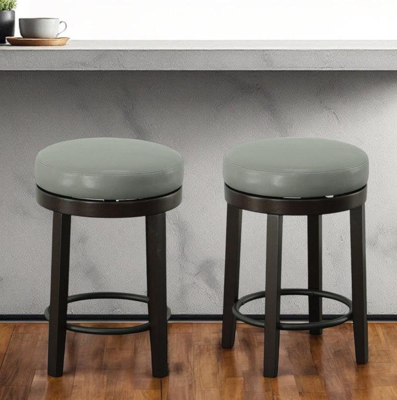 Set of Two 24" Gray and Espresso Faux Leather and Solid Wood Backless Counter Height Swivel Bar Chairs